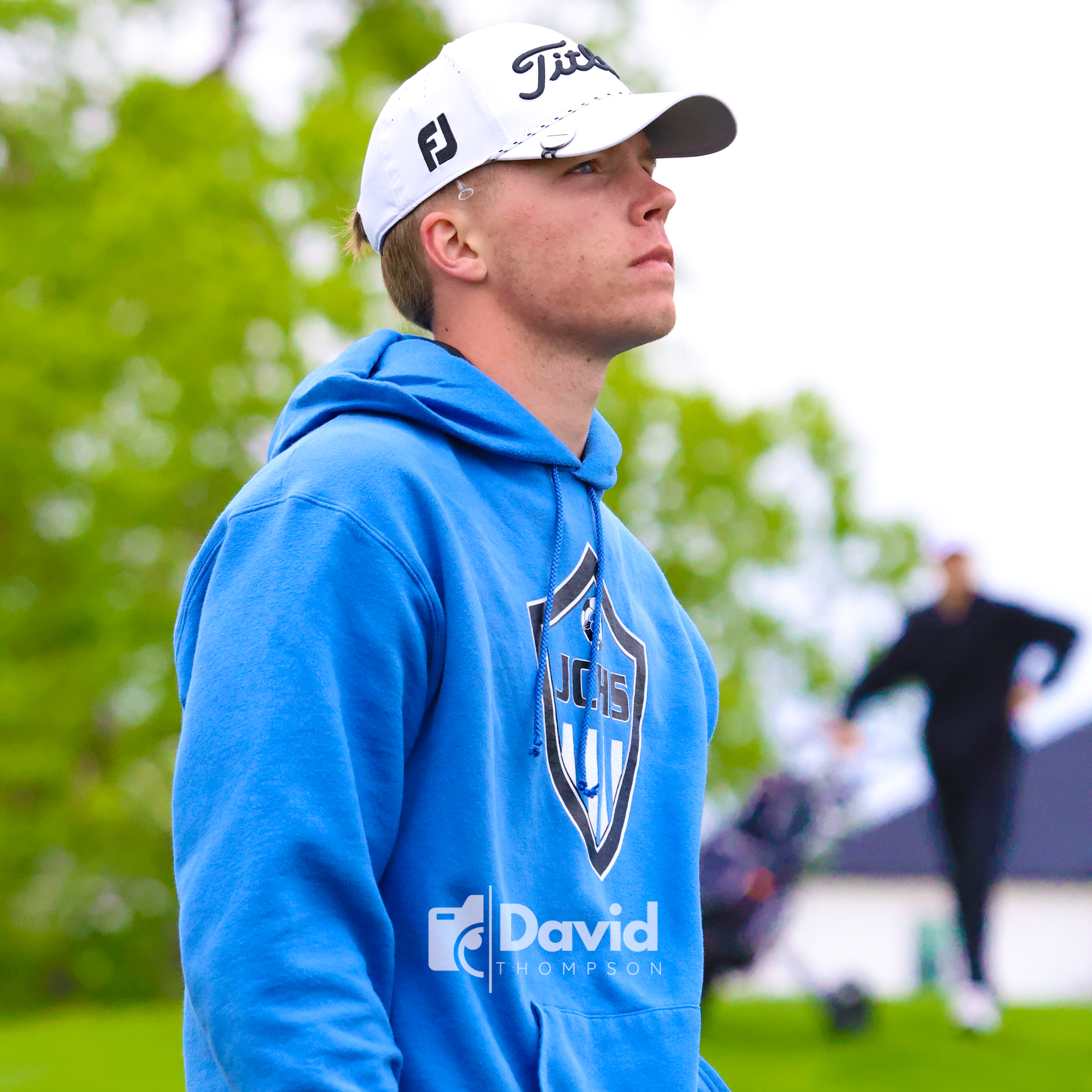 a picture of a man standing at a golf course